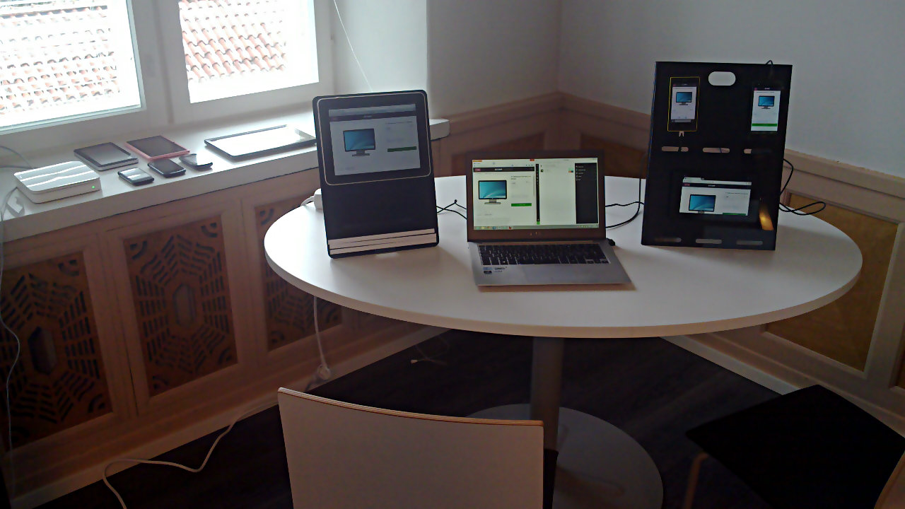 Early lab setup: two stands with various devices
                and a laptop running Ghostlab.